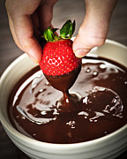 Dipping strawberry in chocolate Photograph by Elena Elisseeva