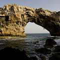 A Man Rock Climbing Deep Water Soloing by Corey Rich A Man Rock Climbing Deep Water Soloing by Corey Rich