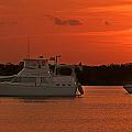 Cabin Cruiser and Red Sunset Over Harbour Photograph by Ginger Wakem