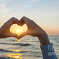 Fingers heart framing ocean sunset Photograph by Elena Elisseeva Fingers heart framing ocean sunset Photograph by Elena Elisseeva