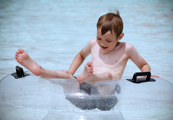 Derrick Neill - A Boy in a Pool in a Transparent Lifesaver