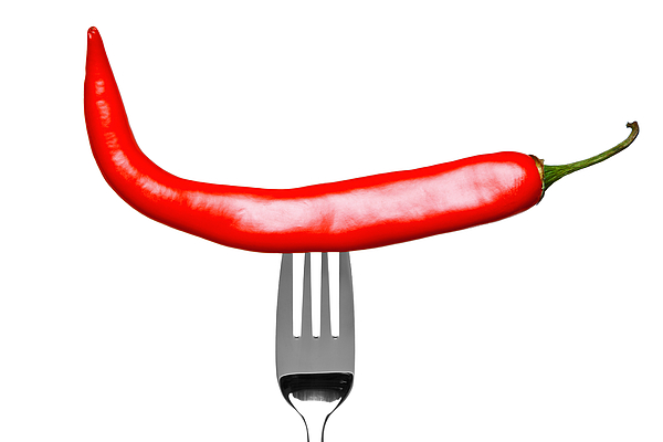 Red Chilli Pepper On A Fork Isolated On White Photograph