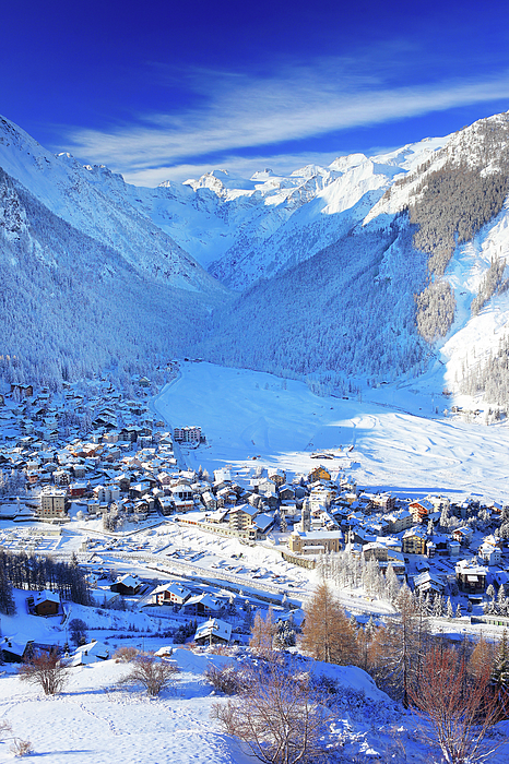 Italy, Aosta Valley, Aosta District, Alps, Val Di Cogne, Cogne, The Village  Of Cogne And The Gran Paradiso Group In Background After A Winter Snowfall 