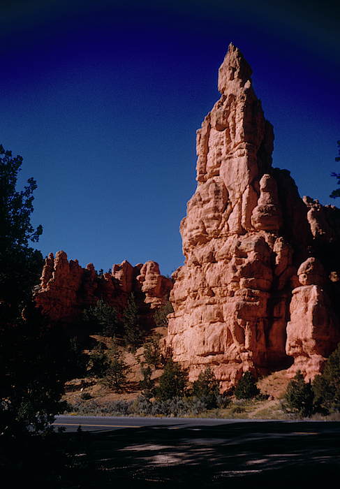 Large sandstone monolith seen beyond a few trees in Oak Creek Canyon -  ARIZ400 00210 Coffee Mug by Kevin Russell - Pixels