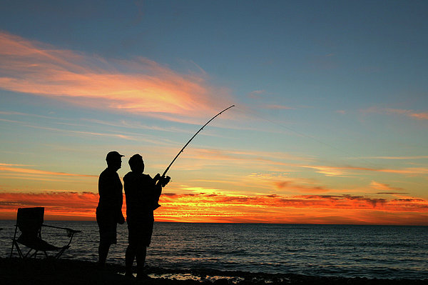 A Silhouette Of Two Men Fishing At Zip Pouch by Jamesbowyer 