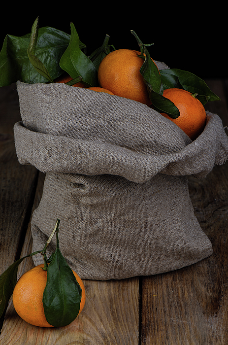 Fresh tangerines in a bag of coarse fabric. Beach Towel by Sergei Dolgov -  Pixels