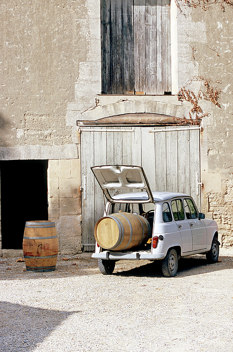 Old Renault In Front Of Vineyard Laden With Wine Barrel In Trunk