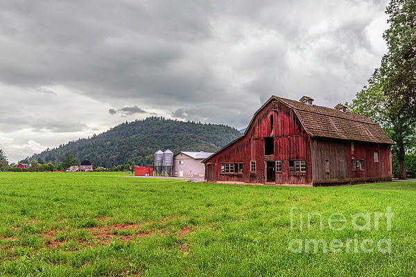 https://images.fineartamerica.com/images/artworkimages/medium/2/old-wooden-and-new-metal-barns-stand-in-a-field-on-green-grass-viktor-birkus.jpg