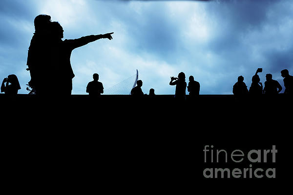 Silhouette of unrecognizable people pointing with a dark