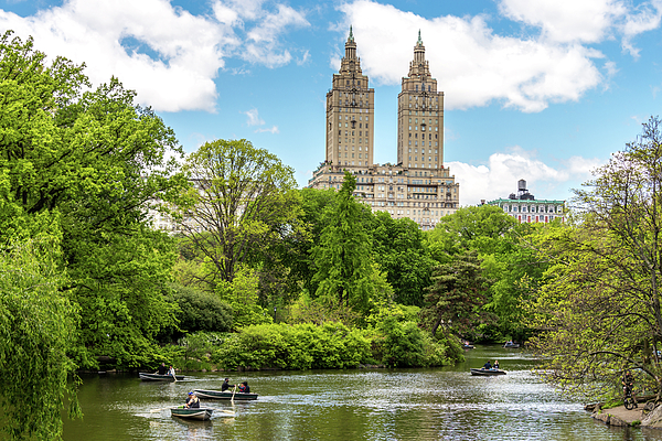 Row boats in lake in Central Park with Eldorado building in