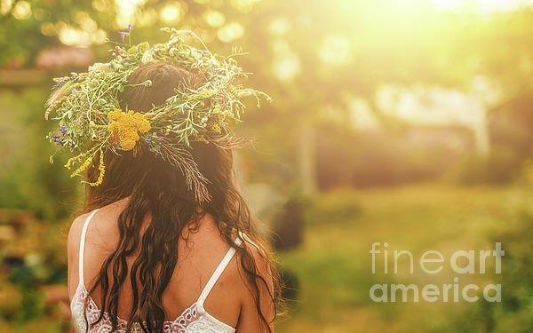 Women in flower wreath on sunny meadow, Floral crown, symbol of