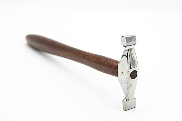 A chasing hammer lying on a white background #6 Photograph by Stefan Rotter  - Fine Art America