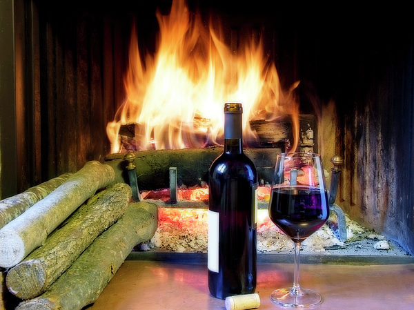 A Glass Of Wine In Front Of A Fireplace Fleece Blanket by Flavio