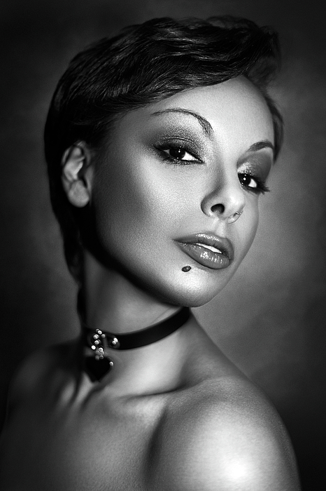 Sonyah Kross - Dramatic black and white studio portrait photograph of a short hair woman wearing a heart necklace