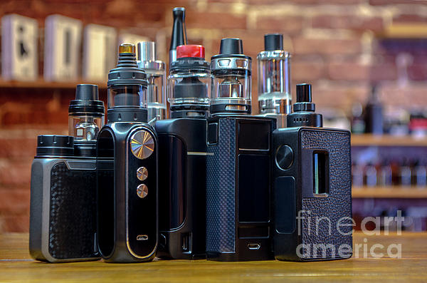 Electronic cigarette on a background of vape shop. E cigarette for