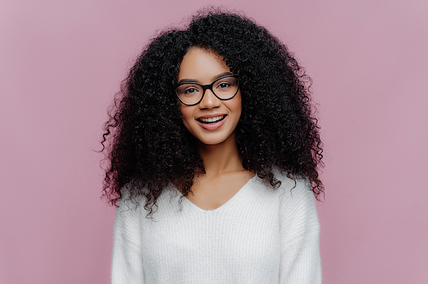 Pretty girl wear black glasses and pose to camera in yellow background  studio by Serhiy Hipskyy. Photo stock - StudioNow