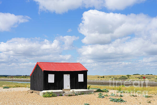 Neale And Judith Clark - Red Roofed Hut, blue sky and clouds Rye Harbour Nature Reserve, Rye, East Sussex, England UK