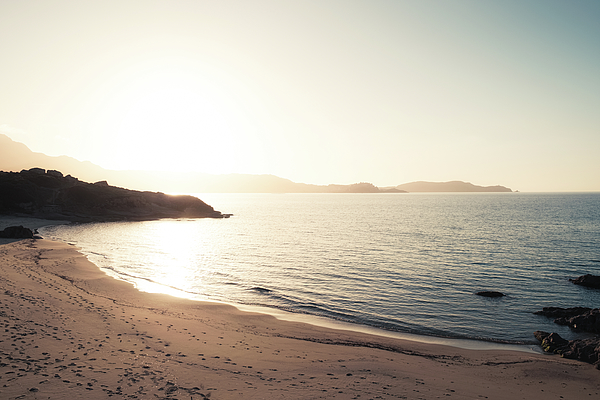 Sun setting over beach and calvi citadel in Corsica Tote Bag by Jon Ingall  - Pixels