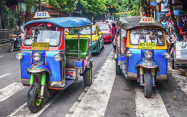 Kevin Hellon - Tuk tuks on a street in the city.