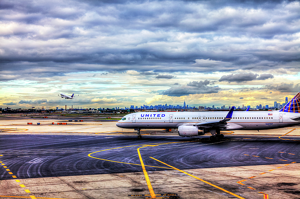 Paul Thompson - United Airlines And Manhattan Skyline At JFK Airport, New York