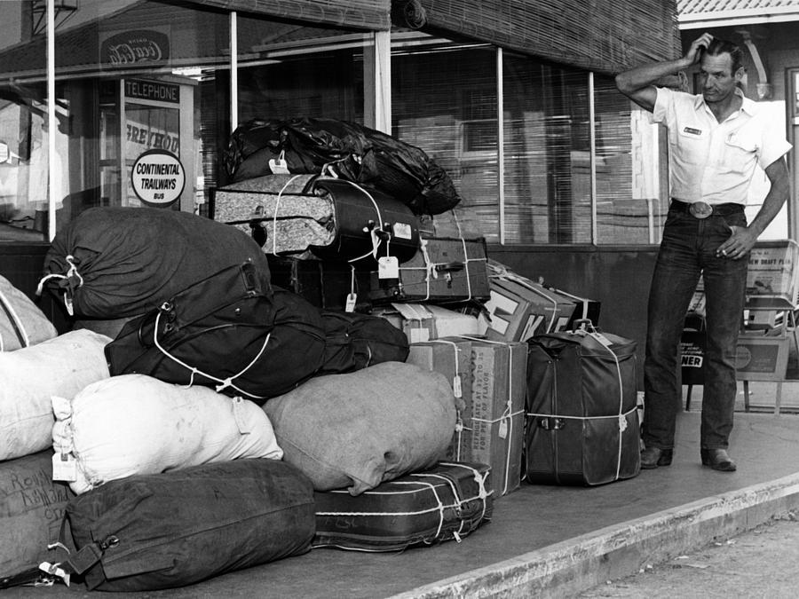 Transportation Photograph -  Baggage Handler Looking Pile Luggage May 1965 by Mark Goebel