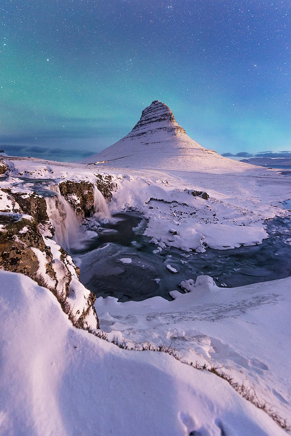 Winter Photograph -  northern lights appear over Mount Kirkjufell in Iceland by Jakkree Thampitakkull