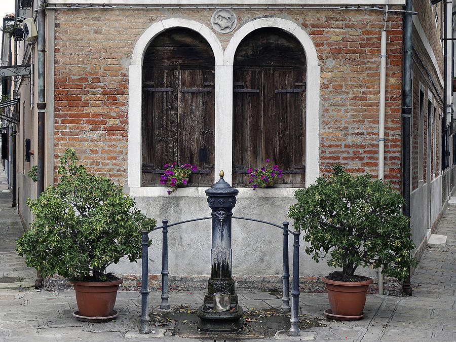A Small Public Fountain On The Island Of Murano In Italy #1 Photograph by Rick Rosenshein