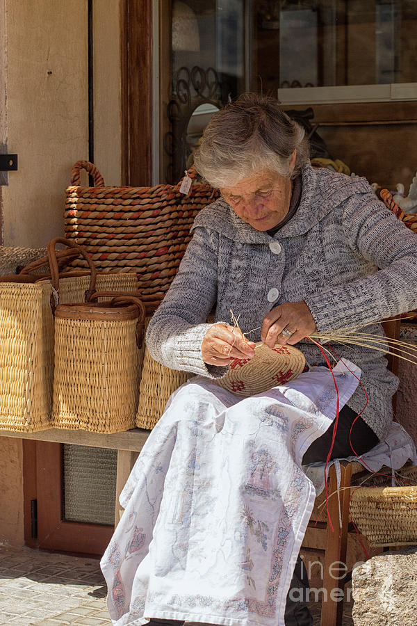 A woman weaving a basket in Sardinia Photograph by Patricia Hofmeester
