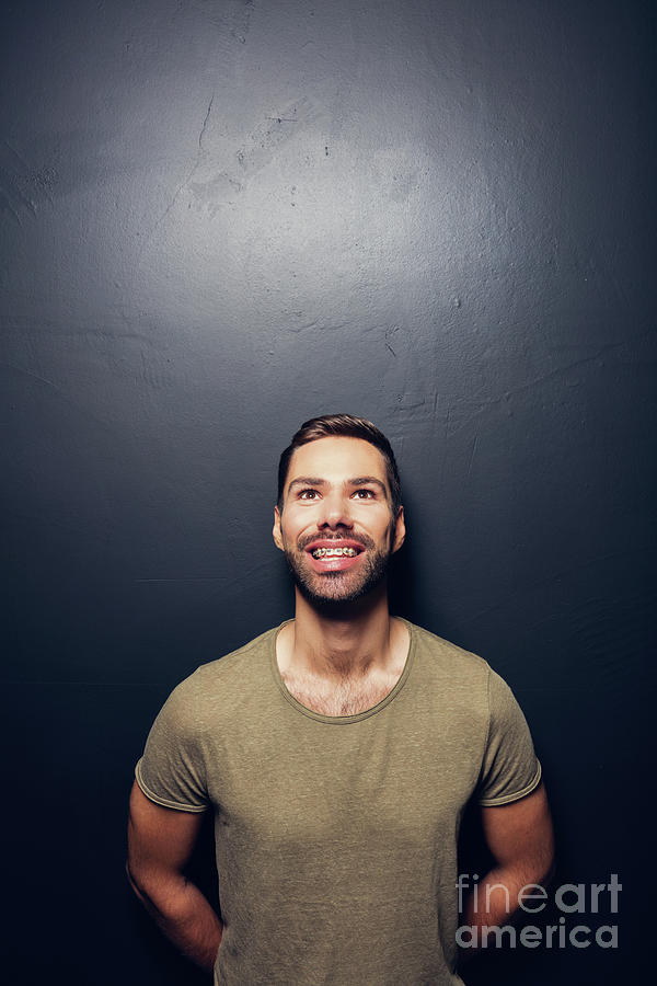 Attractive, Smiling Man Leaning Against The Wall. Photograph