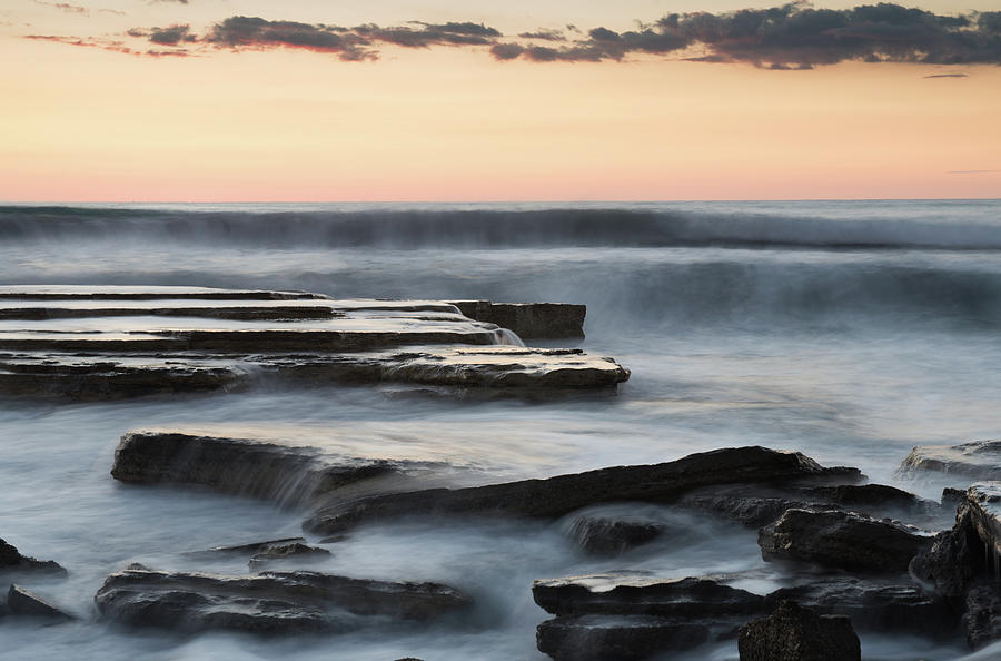 Beautiful dramatic Sunset over a rocky coast #1 Photograph by Michalakis Ppalis