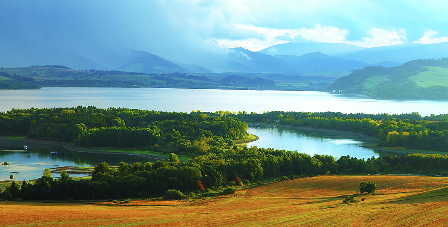 Beautiful landscape, green and yellow meadow and lake with mountain in ...