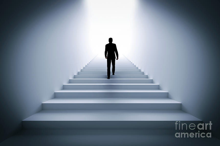 Businessman climbing the stairs towards light. #1 Photograph by Michal Bednarek