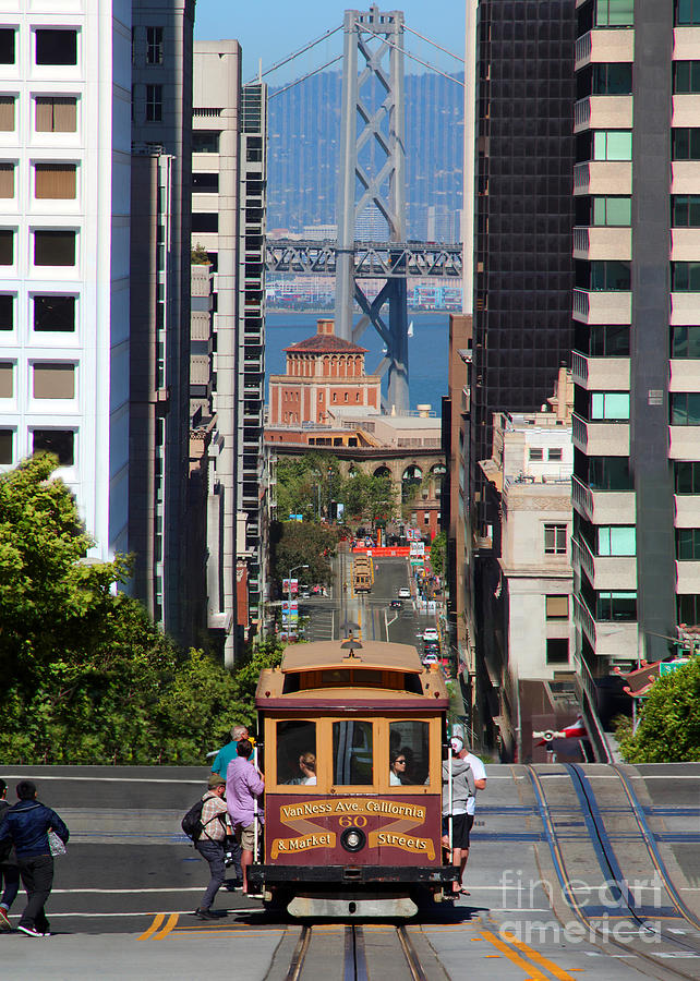 California Street Cable Car and the Bay Bridge #1 Photograph by Wernher Krutein
