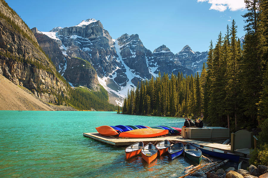 Canoes on a jetty at Moraine lake in Banff National Park, Canada ...