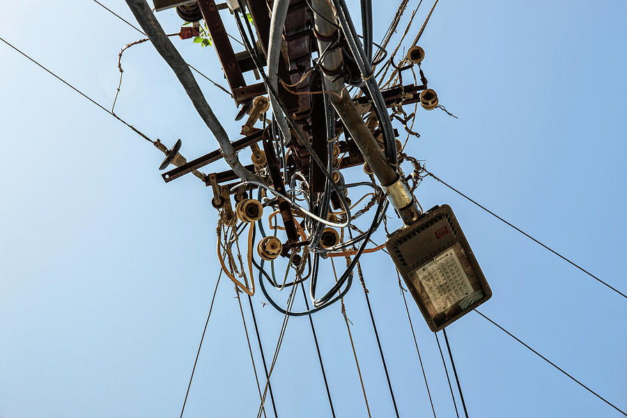 Chaos of cables and wires and broken street lights Photograph by Tjeerd