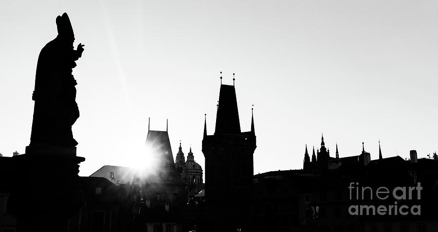 Charles Bridge at sunrise, Prague, Czech Republic. Statues and towers silhouettes #1 Photograph by Michal Bednarek