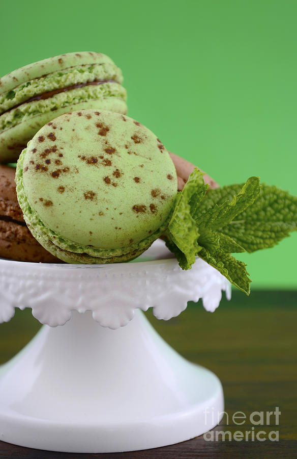 Chocolate and mint flavor macaroons on dark wood table #1 Photograph by Milleflore Images