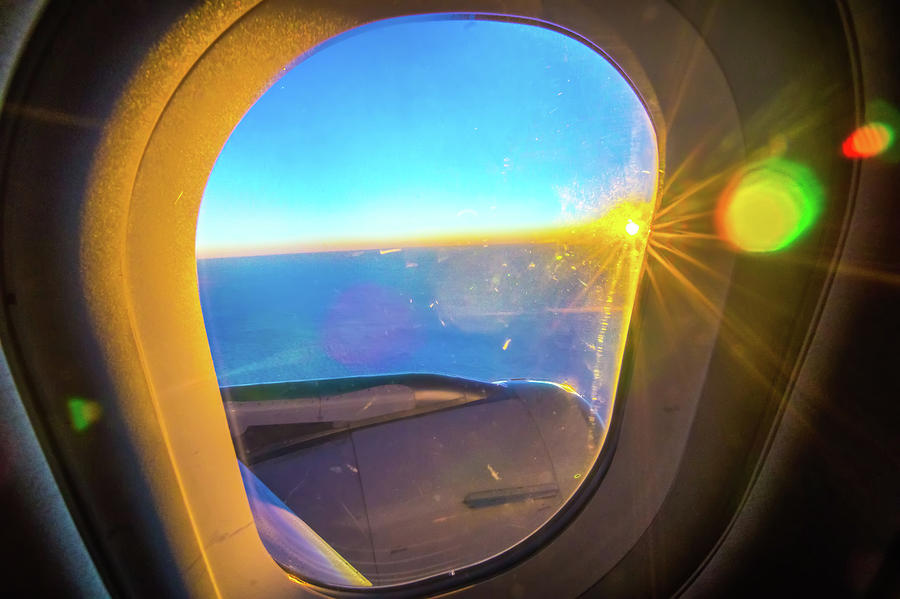 Clouds and sky as seen through window of an aircraft at sunrise #1 Photograph by Alex Grichenko