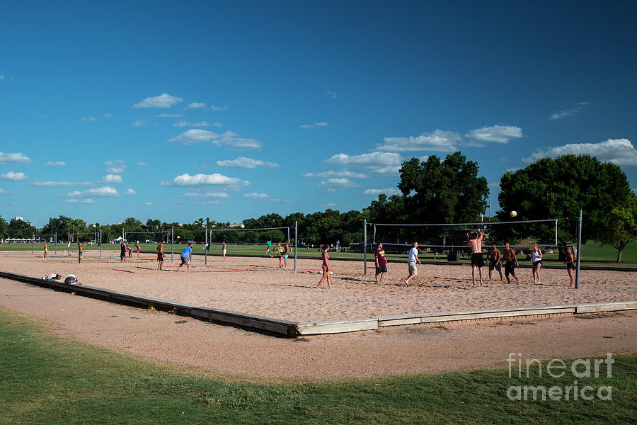 Sports Photograph - Co-eds athletes play volleyball on a beautiful sunny summer day at the sand volleyball courts in Zilker Park #1 by Dan Herron