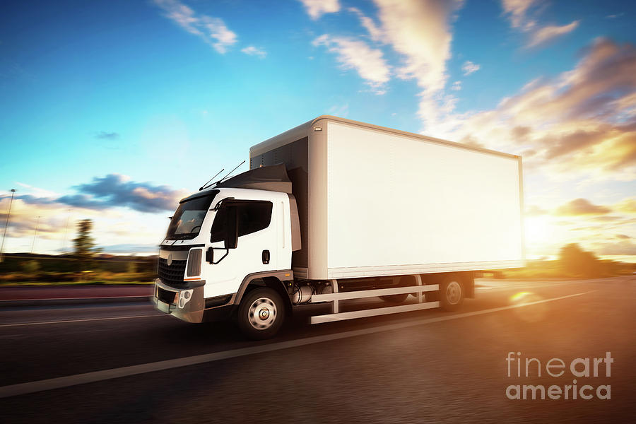Commercial Cargo Delivery Truck With Blank White Trailer Driving On Highway. Photograph