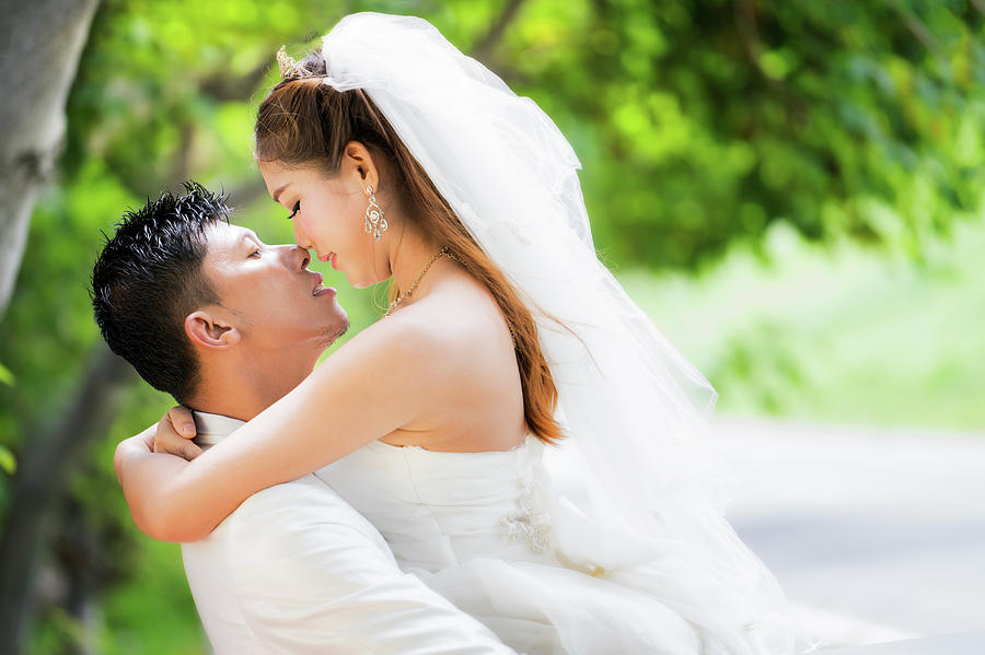 Couple just wedding hug and kiss in nature background #1 Photograph by Anek Suwannaphoom