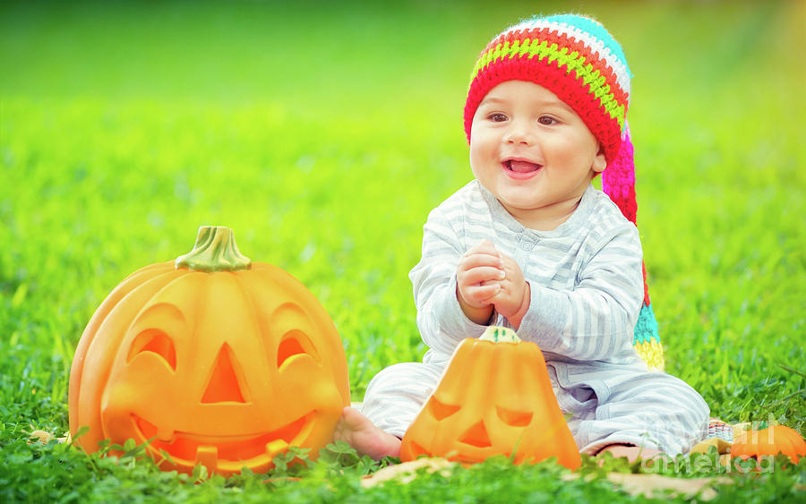 Cute baby with Halloween pumpkins #1 Photograph by Anna Om