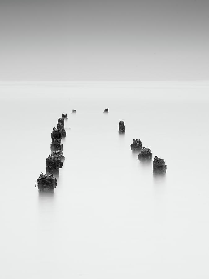 Damaged wooden poles of an old pier in the ocean. #2 Photograph by Michalakis Ppalis