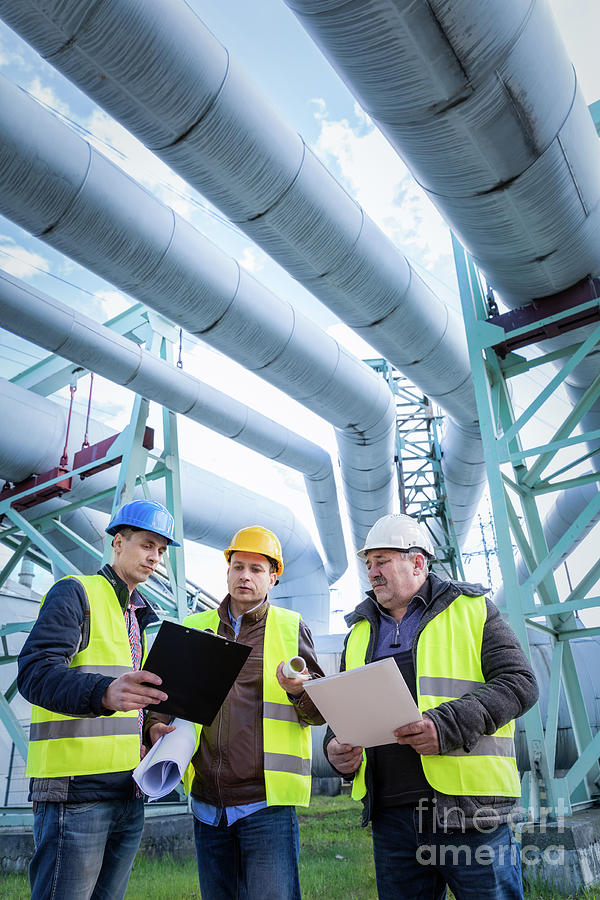 Pipe Photograph - Engineers discussing maintenance of a petrochemical plant #1 by Michal Bednarek