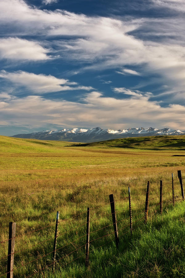 Evening clouds pass over the Zumwalt Prairie and the snow capped ...