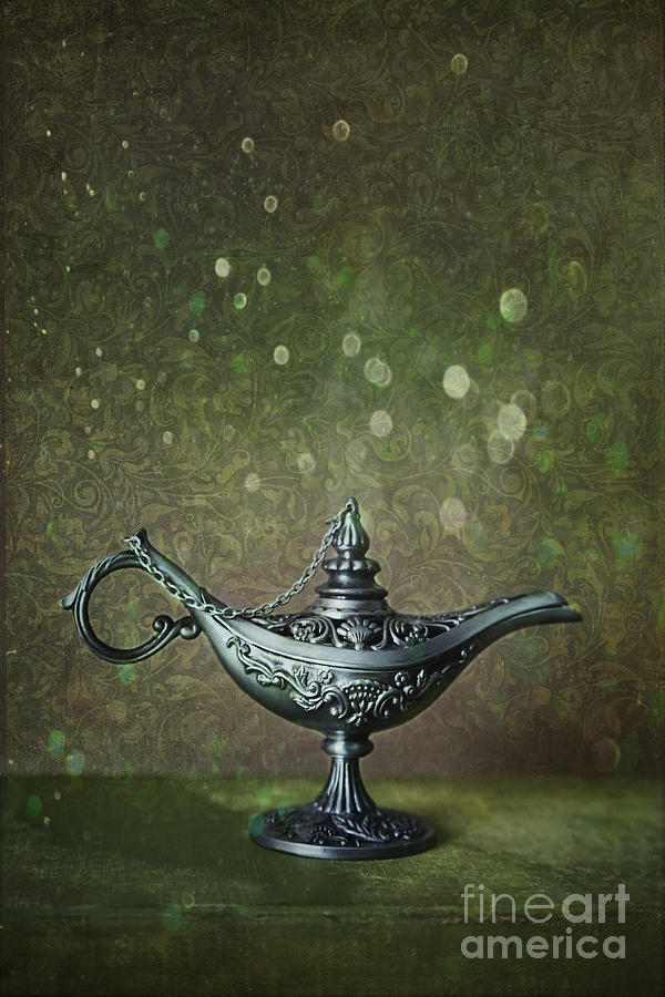 Genie lamp on old book #1 Photograph by Sandra Cunningham