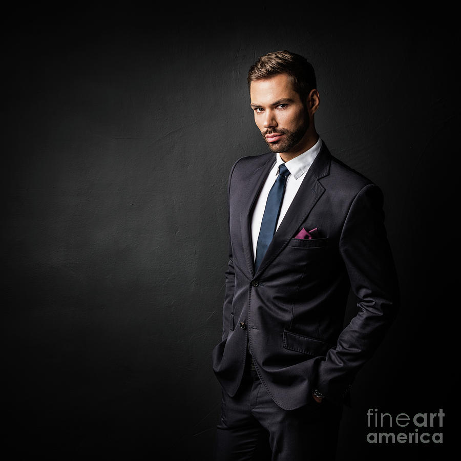 Handsome young businessman standing confident on black #1 Photograph by Michal Bednarek