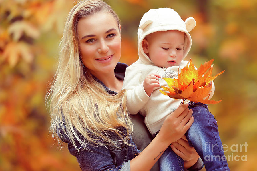 Happy mother with baby in autumn park #1 Photograph by Anna Om