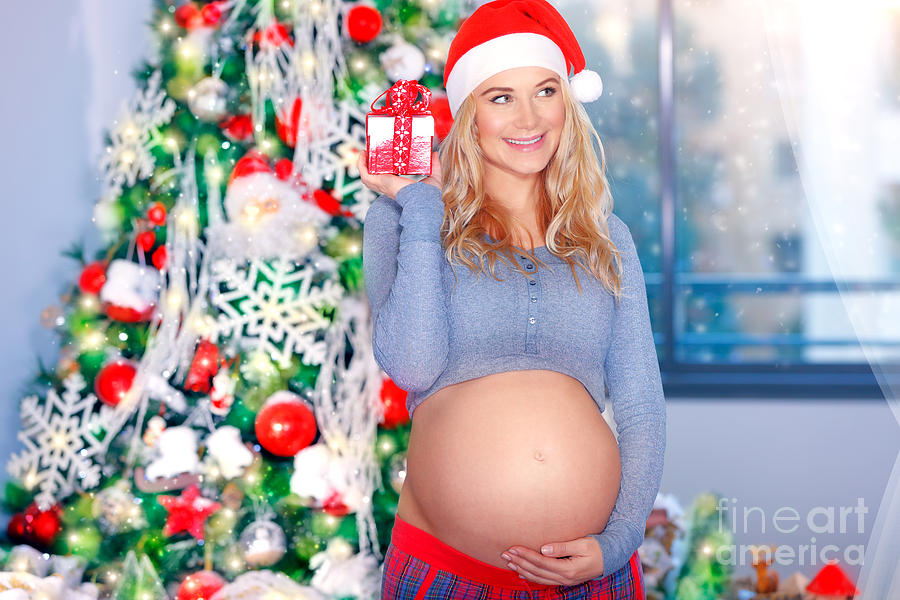 Happy pregnant woman in Christmas eve #1 Photograph by Anna Om
