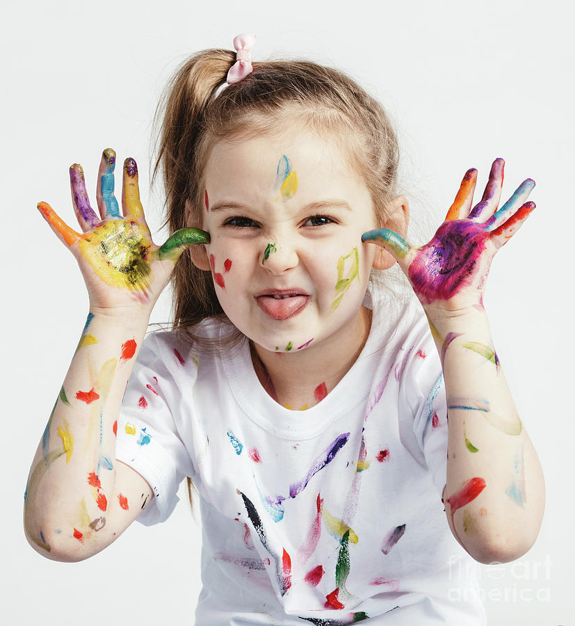 Little girl covered in paint making funny faces. #1 Photograph by Michal Bednarek